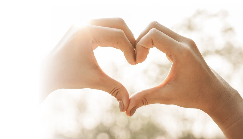 two hands with fingers touching making the shape of a heart