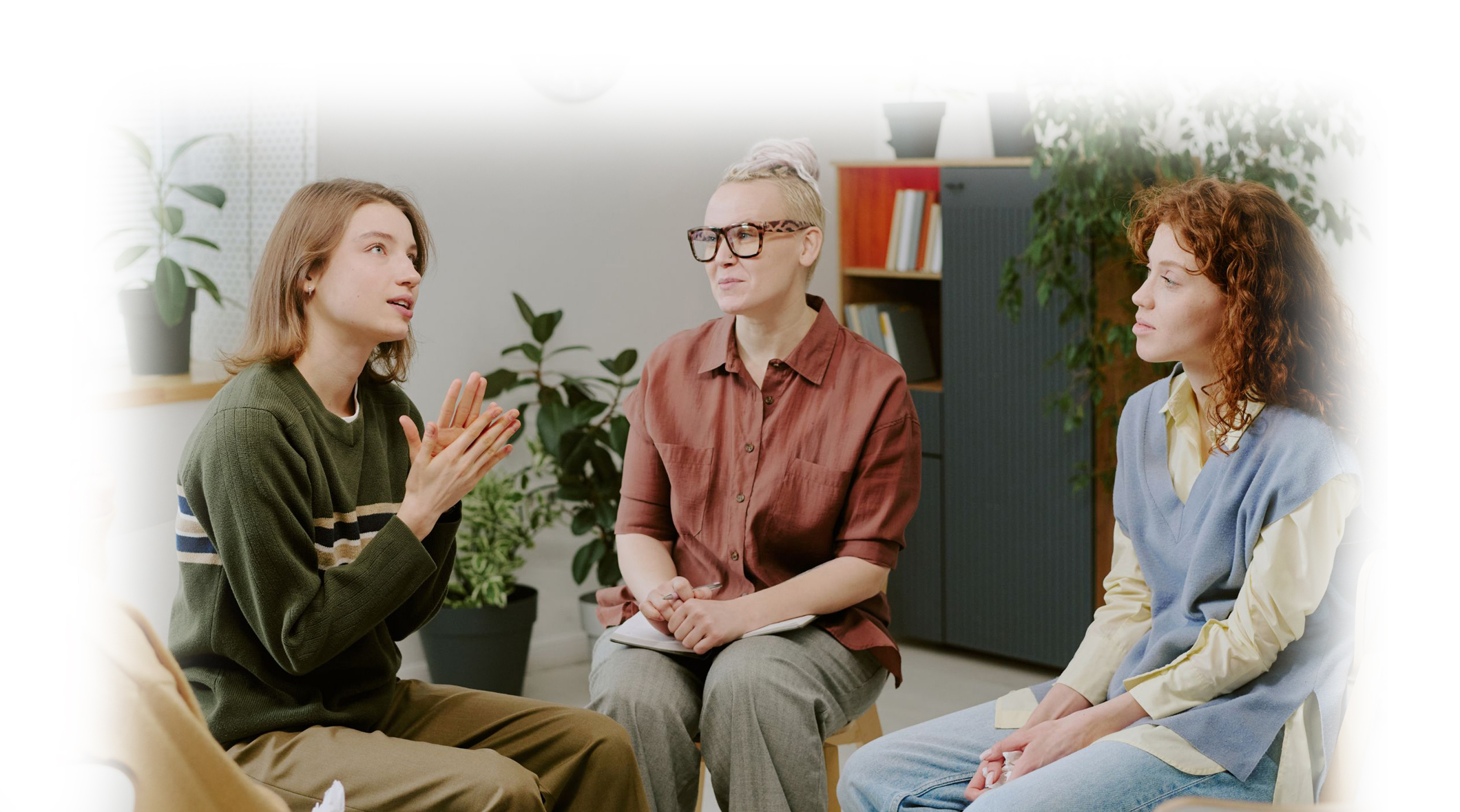 three people in a room talking together